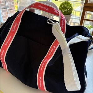 Birddogs Versatile Black Duffel Bag with Red Straps. Extra shoulder white strap